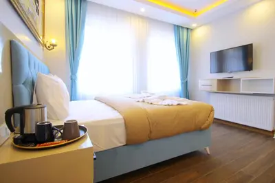 a hotel room with a bed and a television at Hira Hotel in Istanbul