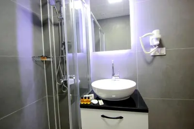 a bathroom with a sink and a shower at Hira Hotel in Istanbul
