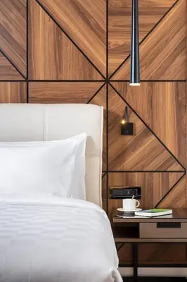 a bedroom with a white bed and a wooden wall at Radisson Blu Hotel, Sakarya in Sakarya