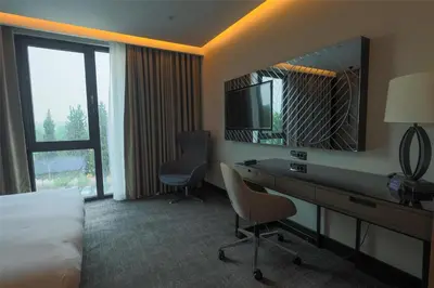 a hotel room with a desk and a mirror at Radisson Blu Hotel, Sakarya in Sakarya