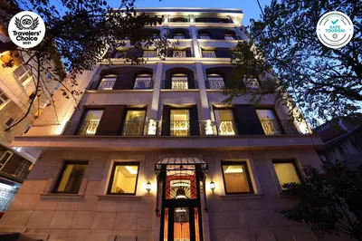 a tall building with a lit up facade at night at The Fox Hotel in Istanbul