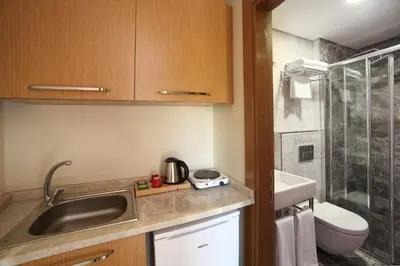 a small kitchen with a sink and a toilet at The Fox Hotel in Istanbul