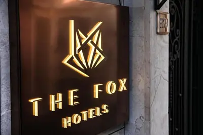 a sign for the fox hotels on the side of a building at The Fox Hotel in Istanbul