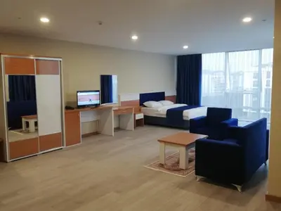 a hotel room with a bed and a couch and chair at SKYBLUE İSTANBUL HOTEL in Istanbul