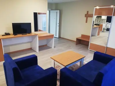 a living room with two blue chairs and a table at SKYBLUE İSTANBUL HOTEL in Istanbul
