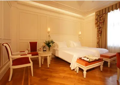 a bedroom with a bed and a table and a chair at Corinne Art & Boutique Hotel in Istanbul