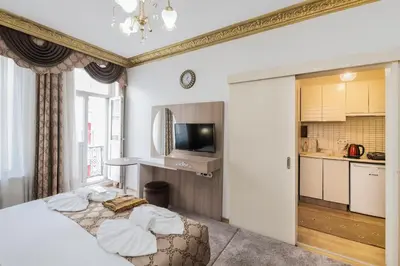 a hotel room with a bed and a kitchen at Punto Suite in Istanbul