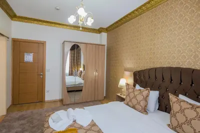 a bedroom with a large bed and a mirror at Punto Suite in Istanbul