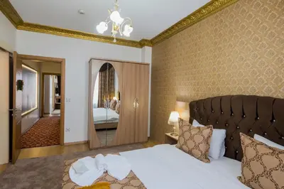 a bedroom with a large bed and a mirror at Punto Suite in Istanbul