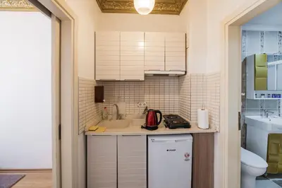 a small kitchen with a sink and a refrigerator at Punto Suite in Istanbul