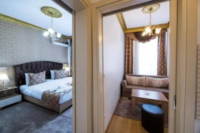a bedroom with a bed and a couch and a table at Punto Suite in Istanbul