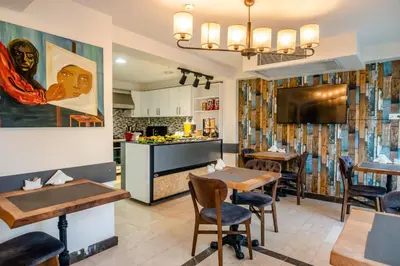 a restaurant with two tables and a kitchen at The Camelot Hotel in Istanbul