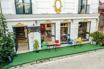 a store with chairs in front of a building at The Camelot Hotel in Istanbul