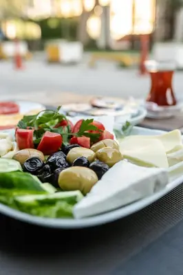 a plate of food with vegetables on a table at The Camelot Hotel in Istanbul