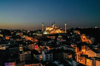 a view of a city at night at The Camelot Hotel in Istanbul