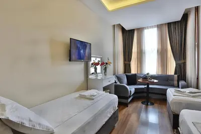 a hotel room with a bed and a couch at Gh Suites Taxim Hotel in Istanbul