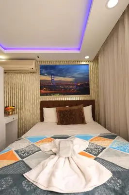 a bedroom with a bed with a dress on it at HamzaBey Hotel in Istanbul