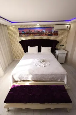 a bedroom with a large bed with a purple mattress at HamzaBey Hotel in Istanbul
