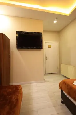 a hotel room with a flat screen tv on the wall at HamzaBey Hotel in Istanbul