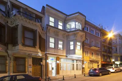 a building on a street with cars parked in front of it at Pi Art Butik Otel in Istanbul