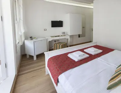 a bedroom with a bed with two towels on it at Pi Art Butik Otel in Istanbul