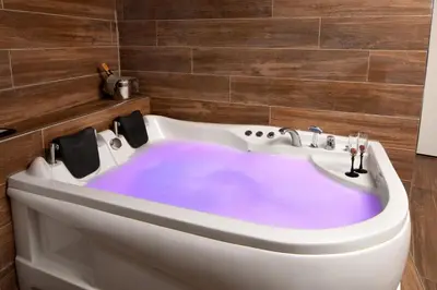 a bath tub with purple dye in a bathroom at Bakırköy Zeugma Suit Otel in Istanbul