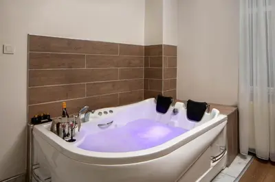 a white bath tub in a bathroom at Bakırköy Zeugma Suit Otel in Istanbul
