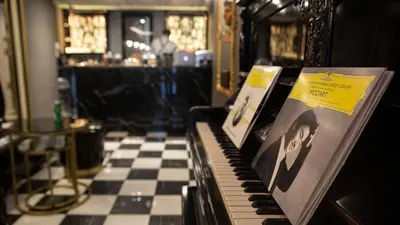 a piano in a room with a checkered floor at Lord Morgan & Exclusive Design Residence Nişantaşı in Istanbul