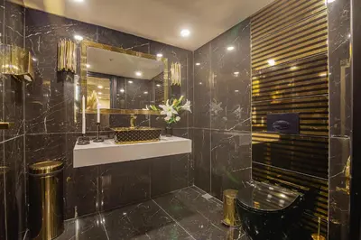 a bathroom with a sink and a mirror at Lord Morgan & Exclusive Design Residence Nişantaşı in Istanbul