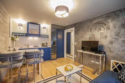 a kitchen and a living room with blue walls at Lord Morgan & Exclusive Design Residence Nişantaşı in Istanbul