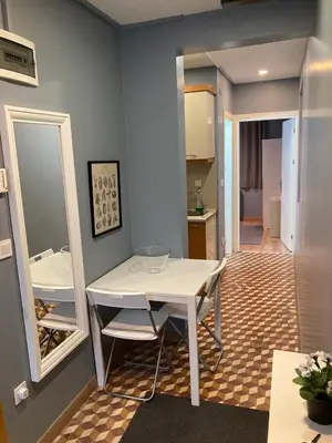 a dining room with a white table and mirrors at Oval Flats Old City in Istanbul