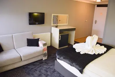 a hotel room with a bed and a couch at Comfort Downtown Istanbul Hotel in Istanbul