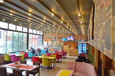 a restaurant with tables and chairs and people sitting at tables at Comfort Downtown Istanbul Hotel in Istanbul