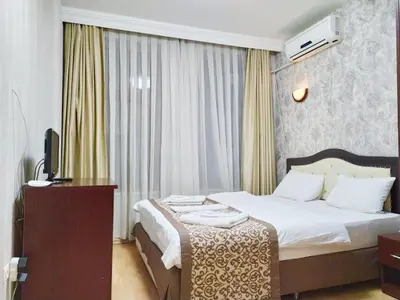 a hotel room with a bed and a television at Taxim Hotel Marin in Istanbul