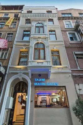 a building with a sign for a marilynma suites at Taxim Hotel Marin in Istanbul