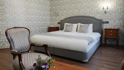 a hotel room with a bed and a chair at Hotel Gritti Pera & Spa in Istanbul