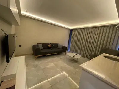 a living room with a couch and a table at Le Luxe Suites Hotel in Bursa