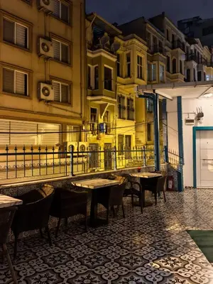 a restaurant with tables and chairs in a street at Old City Pansiyon in Istanbul