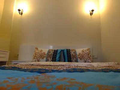 a bed in a room with two lights on the wall at Old City Pansiyon in Istanbul