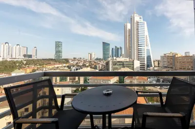a table and chairs on a balcony with a view of a city at Hotel Boursier 2 & Spa in Istanbul