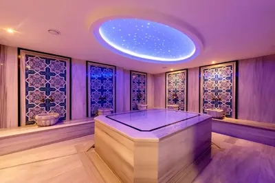 a room with a bar with purple lighting and stained glass windows at Hotel Boursier 2 & Spa in Istanbul