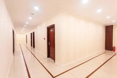 a hallway with white walls and wooden doors at Marina Park Hotel in Istanbul
