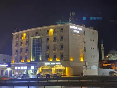 a building with cars parked in a parking lot at night at Marina Park Hotel in Istanbul