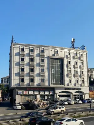 a large building with cars parked in a parking lot at Marina Park Hotel in Istanbul