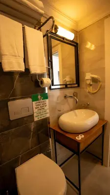 a bathroom with a toilet and a sink and a mirror at Farina Hotel By Cigno in Istanbul