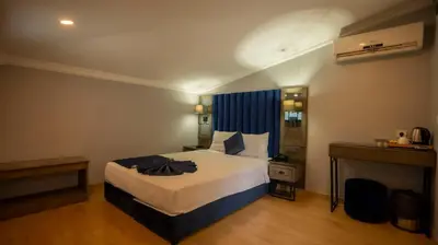 a hotel room with a bed and a desk at Farina Hotel By Cigno in Istanbul