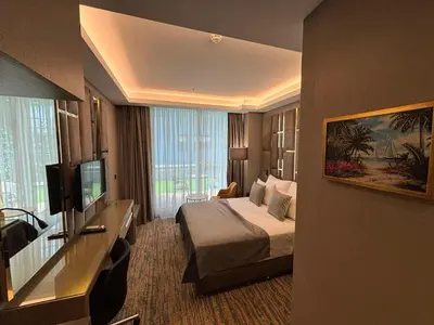 a hotel room with a bed and a flat screen tv at Best Western Premier Ottoperla Hotel in Istanbul