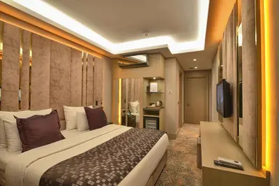 a hotel room with a large bed and a television at Best Western Premier Ottoperla Hotel in Istanbul