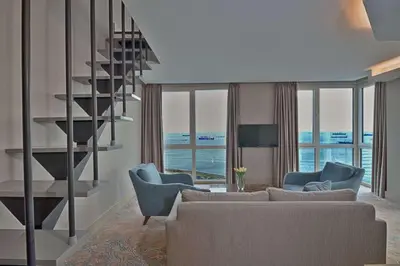 a living room with a spiral staircase and a couch and chairs at Best Western Premier Ottoperla Hotel in Istanbul