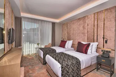 a hotel room with two beds and a television at Best Western Premier Ottoperla Hotel in Istanbul